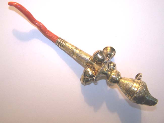 An early 19th century English Engraved Silver-Gilt Childs' Rattle, Whistle and Bells with Carved Coral Stem